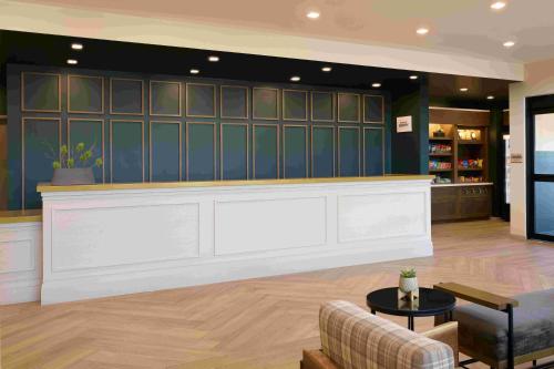 a lobby with a bar with a couch and a table at TownePlace Suites by Marriott Avon Vail Valley in Avon