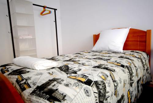 リスボンにあるSombrero Apartment Graçaのベッドルーム(キルト付きのベッド付)