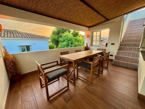 a dining room with a table and chairs and a window at Villa Harmony in Mijas Costa