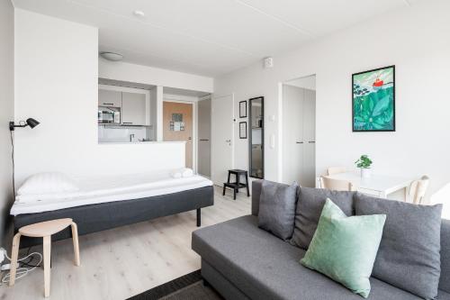 a living room with a bed and a couch at Hiisi Homes Kangasala in Suorama
