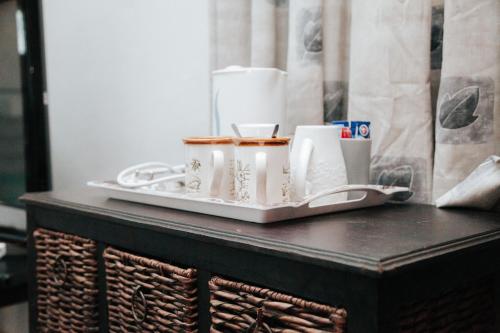 a tray with cups and cups on a table at Bailey Country House in Queenstown