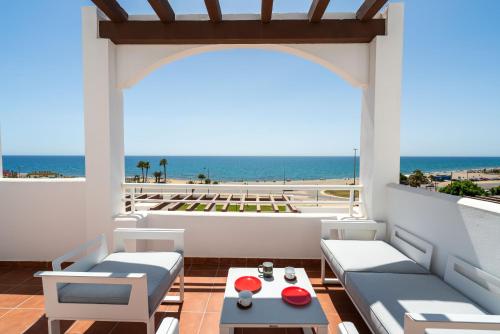 a balcony with a view of the ocean at AlmeriaSuite Mojacar Breeze Apartments in Mojácar