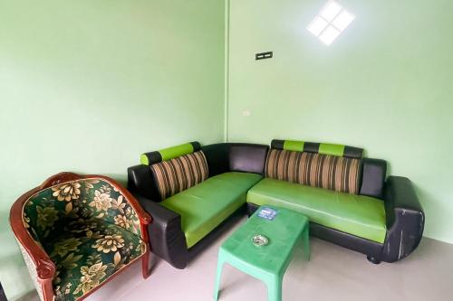 a living room with a couch and a table at RedDoorz near Kantor Bupati Tapanuli Tengah Aek Tolang in Halangan