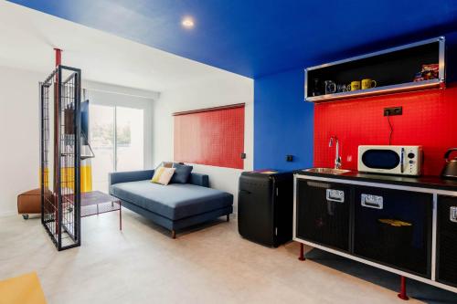 a living room with a blue and red wall at Ryans Lolas - Adults Only in San Antonio Bay