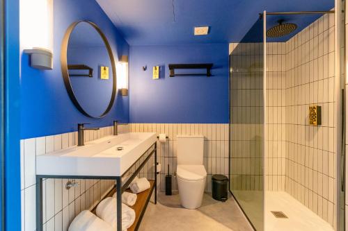 a bathroom with a sink and a toilet and a mirror at Ryans Lolas - Adults Only in San Antonio Bay