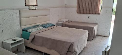 a bedroom with two beds in a room at Hotel Recanto da lagoa in Juazeiro do Norte