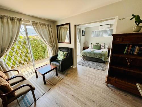 a living room with a bed and a chair at D'urban Ridge Self catering Apartment in Cape Town