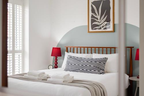 a bedroom with a white bed with two towels on it at Stylish & Chic 3 bed House in Cambourne