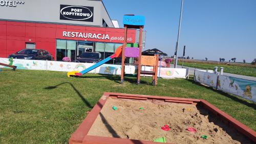 a sandbox in front of a building with a sand pit at Hotel Picaro Kopytkowo A1 in Kopytkowo
