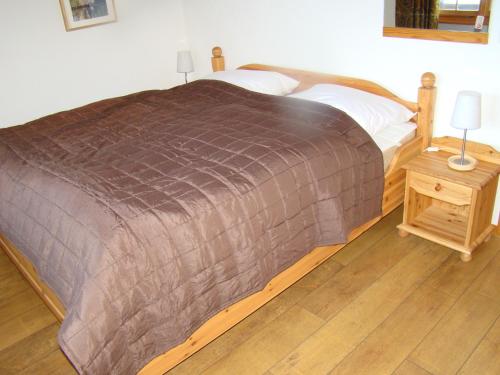 a bedroom with a large bed and two night stands at Chalet Sandrine in Grächen