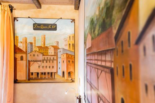 a picture of a painting of a city on a wall at Art Hotel Commercianti in Bologna