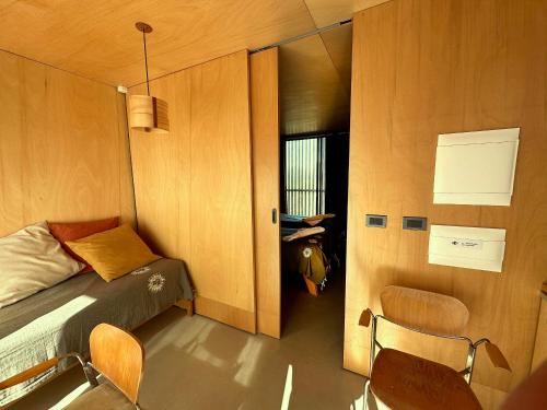 a small room with a bed and two chairs at CABITO B & B in La Paloma