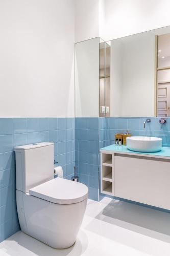 a bathroom with a white toilet and a sink at Camões Appartments in Porto