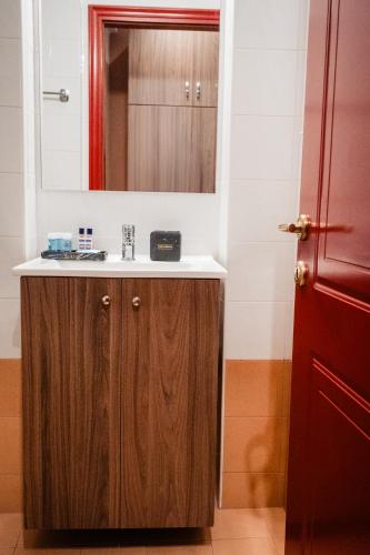 a bathroom with a sink and a mirror at Central in Komotini