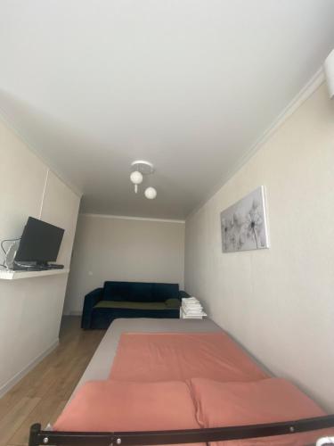 a small room with a bed and a couch at 1кмн Квартира по проспекту Республика 30 in Astana