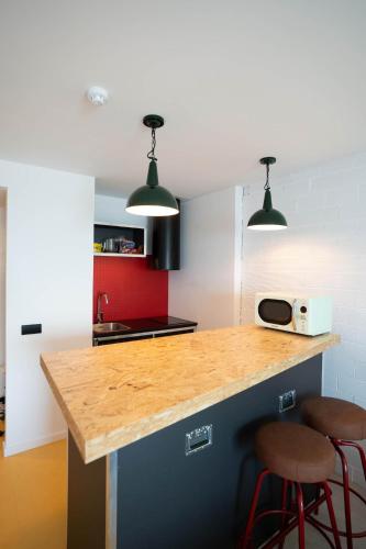 a kitchen with a counter and two stools at Ryans Lolas - Adults Only in San Antonio Bay