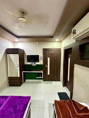 a room with a bed and a tv in it at Hotel City Gold in Ajmer