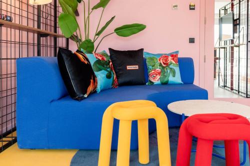 a blue couch with two chairs and a table at Ryans Lolas - Adults Only in San Antonio Bay