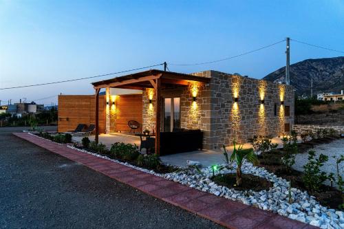 a small house with lights on the side of it at Holy Sea Smart Suites in Elafonisi