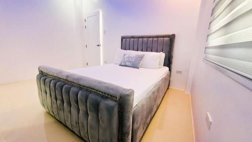 a bed in a room with a leather bed frame at One Bedroom in CazaTara - Modern Villa with Pool in Alaminos