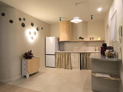a kitchen with a white refrigerator and a counter at Miña Nai Apartment in Ferrol