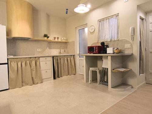 a kitchen with white cabinets and a counter top at Miña Nai Apartment in Ferrol