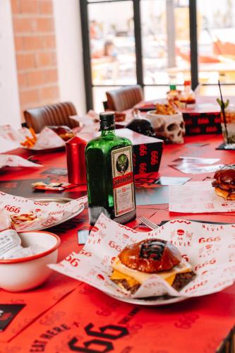 a table with a bottle of sauce and food on it at Ryans Lolas - Adults Only in San Antonio Bay