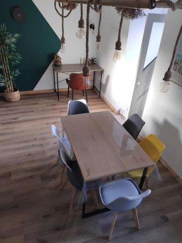a conference room with a wooden table and chairs at La grange aux animaux in Tollevast