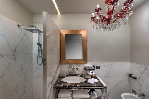 a bathroom with a sink and a mirror at Art Hotel Commercianti in Bologna