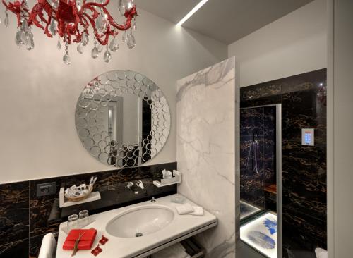 a bathroom with a sink and a mirror at Art Hotel Commercianti in Bologna