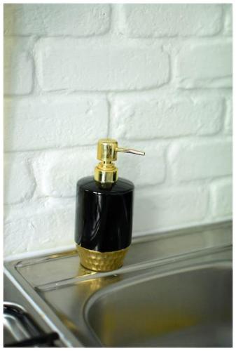 a soap dispenser sitting on top of a sink at Color 24 Apartament Relaks in Stalowa Wola
