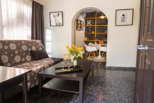 a living room with a couch and a table at Cozy near the sea-Sunset View Apartments in Ixia