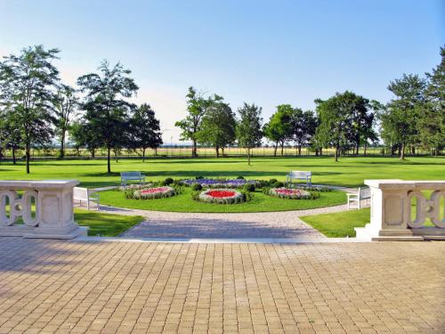 a park with benches and flowers in a park at Art Hotel Kaštieľ in Tomášov
