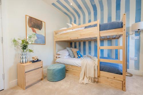 a bedroom with a bunk bed with a ladder at Coastal Location - Sleeps 6 & Pet Friendly in Bangor