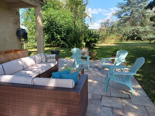 three blue chairs and a couch on a patio at Chateau in sw France - Comfortable 6 Bedroom House in Sariac-Magnoac