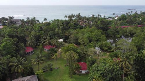an aerial view of a resort with the ocean at Subodinee Bungalow in Weligama