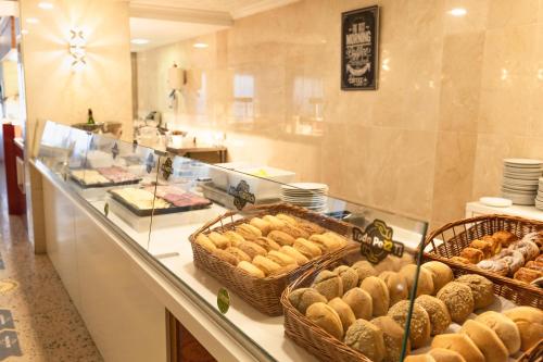 a bakery with baskets of pastries on a counter at R2 Veronica in Cala Millor