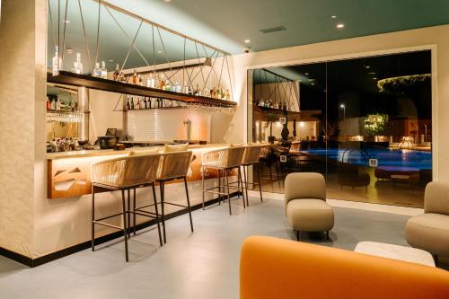 a bar in a restaurant with chairs and tables at R2 HIGOS BEACH in Costa Calma
