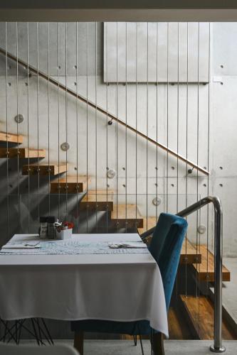 a table and a blue chair next to a staircase at 7 on Marine in Hermanus