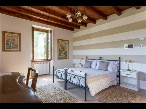 Кровать или кровати в номере B&B Ronco degli Ulivi