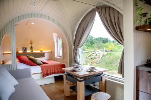 a bedroom with a bed and a window at Les Nuits de Thoiry in Thoiry