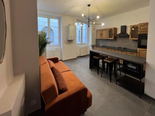 un salon avec un canapé et une cuisine dans l'établissement Appartement Deluxe - Jean Jaurès, à Saint-Étienne
