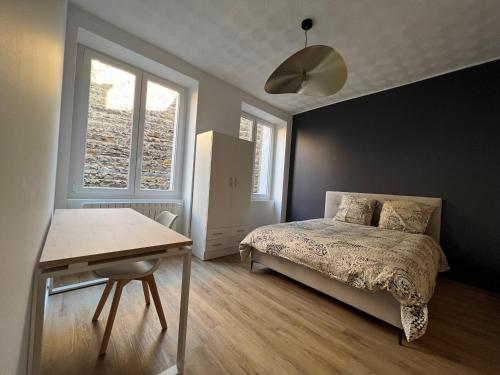 - une chambre avec un lit, une table et une fenêtre dans l'établissement Appartement Deluxe - Jean Jaurès, à Saint-Étienne