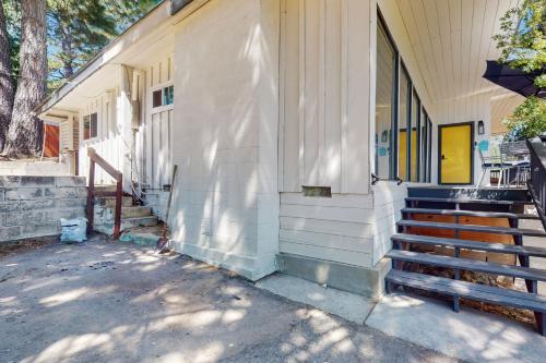 a building with stairs next to a house at Honea Bee Hideout in Bass Lake Annex