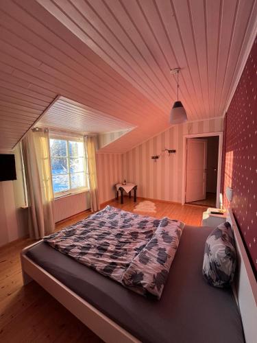 a large bed in a room with a ceiling at Room Sebi in Arvidsjaur