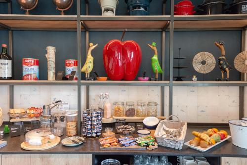 a shelf with food and other items on it at Boutique Hotel Herbergh Amsterdam Airport FREE PARKING in Badhoevedorp