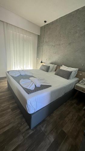 a bedroom with a large bed with white sheets at Remis Studios in Rethymno Town