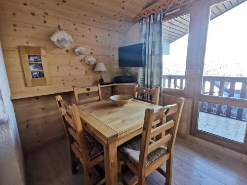une salle à manger avec une table et des chaises en bois dans l'établissement Charmant appartement à Méribel, 1 chambre, au pied des pistes, équipé et confortable - FR-1-355-32, à Méribel