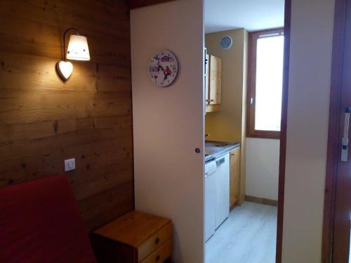 une petite cuisine avec une horloge murale dans l'établissement Appartement rénové à Méribel, 1 chambre, 3 couchages, balcon, accès pistes, casier à skis, WIFI - FR-1-355-175, à Les Allues