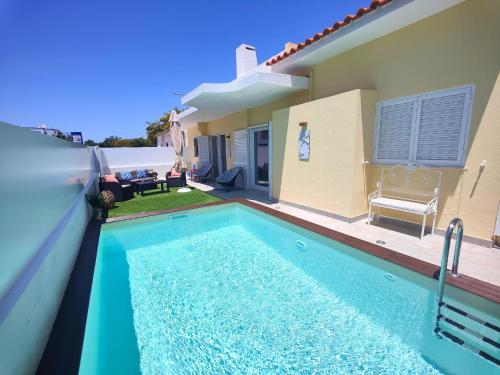 a swimming pool in front of a house at Casa Titi-stunning Holiday Home With Private Pool in Tavira